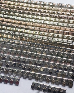 Macro display of diverse Italian charm links in gold and silver for DIY bracelets