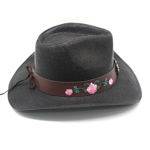 Close-up of black straw cowboy hat with embroidered pink roses on leather band