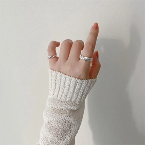 Minimalist 925 sterling silver twisted braided rings stacked on female hands