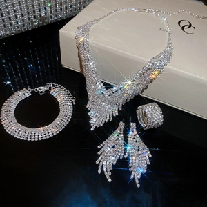 Macro view of bridal jewelry set with sparkling V-shaped tassel necklace and earrings