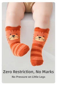 Detailed view of striped baby socks with a cute orange tiger head and elastic soft cuffs