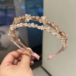 Detailed view of handmade crystal headbands in soft pink and champagne beige tones