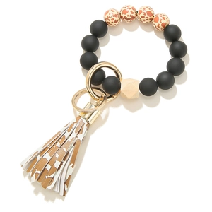 Detail of matte black silicone beads with leopard print and tassel keychain ring