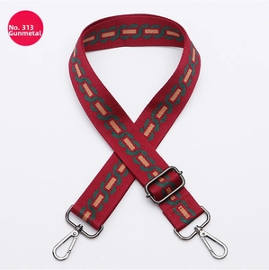 Detail of adjustable burgundy woven shoulder strap with gunmetal swivel hooks and buckle