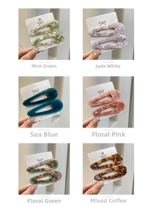Close-up of acetic acid marble pattern teardrop hair clips in six distinct colors