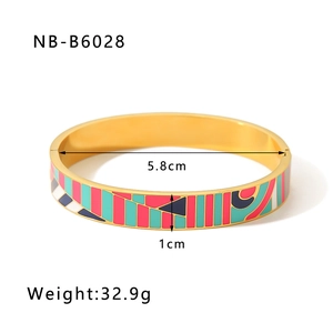 Detail view of 18k gold plated bangle with colorful enamel geometric patterns and size data