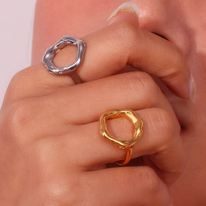 Macro shot of irregular hollow ring with lava texture in gold and silver finish
