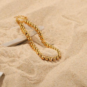 Detailed view of 18K gold plated steel bead bracelet with lobster clasp on natural stones