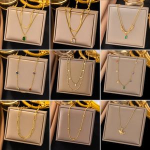 Collection of golden minimalist necklaces with varied chains and gemstone pendants