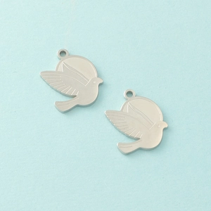Polished stainless steel dove pendants for jewelry making on a light blue background