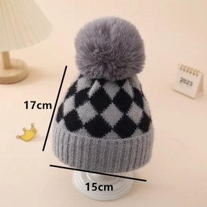 Detail view of a plaid knit baby hat with dimensions 17cm by 15cm and a fluffy pom-pom