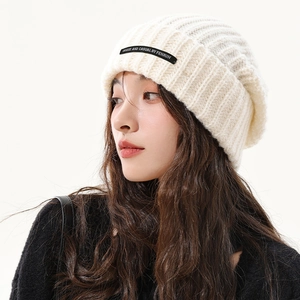 White slouchy knit beanie for women in warm ribbed texture with casual leather patch