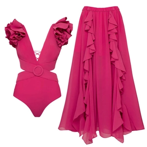Detail of magenta cut-out swimsuit with 3D floral shoulder and matching long ruffled skirt