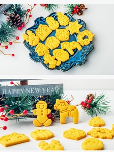 Close-up of yellow Christmas cookies featuring gingerbread man and tree on a plate