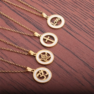 Chic gold star and cross necklaces with white shell inlay on a natural wood surface