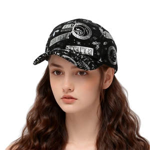 Detail of black cotton baseball cap with silver reflective Christmas prints and stars