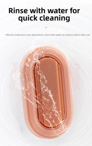 Detail view of pink silicone bath brush with dense bristles showing easy rinse feature