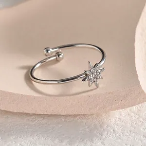 Elegant adjustable silver star ring featuring shimmering pavé zircons on a pink stand