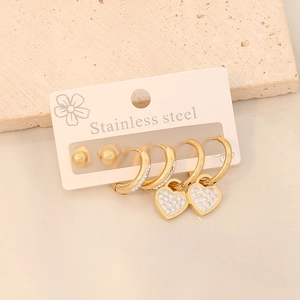 Three pairs of stainless steel gold earrings with heart pendants and crystal accents