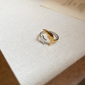 Detailed view of sun and moon open ring with 18k gold plating and embossed face motif