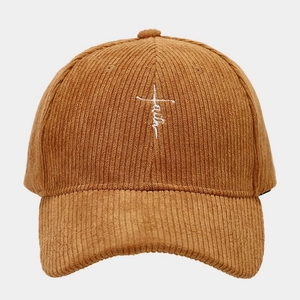 Detailed close-up of khaki corduroy fabric and faith cross embroidery on baseball cap