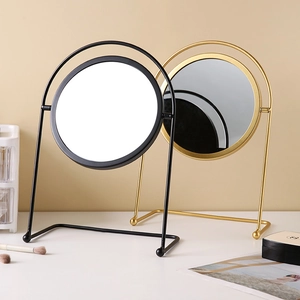 Modern desktop iron makeup mirrors in black and gold with a rotating round metal frame