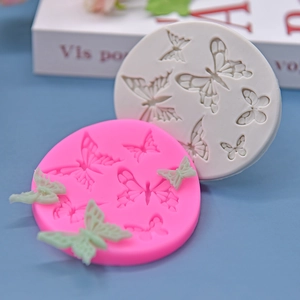 Butterfly silicone mold set for DIY cake decorating and chocolate crafting on blue table