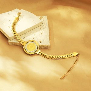 Macro detail of 18K gold-plated coin pendant bracelet with sparkling zircon inlays