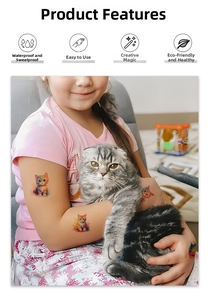 Close-up of waterproof temporary tattoo stickers with colorful cartoon cat designs on skin