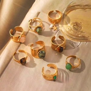 Detailed view of eight vintage gold stainless steel rings with natural stone accents