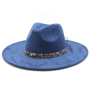 Close-up of navy blue fedora with ethnic band featuring evil eye and metal studs