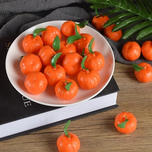 Lifelike PVC mini orange models with green leaves in a cozy tabletop decoration setup