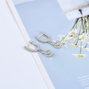 Silver snake drop earrings with pave set zircons in a minimalist luxury design