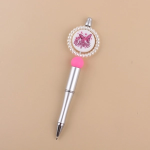 Close-up of pink hope butterfly badge with pearl trim on a stylish beaded pen