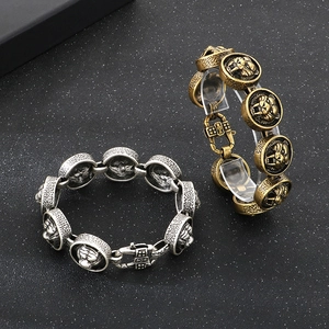 Vintage punk style tiger head bracelets in antique gold and silver finishes on black background