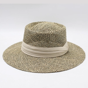 Classic wide brim straw boater hat with a beige pleated ribbon on white background