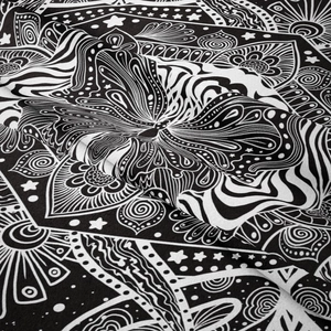 Close-up of bohemian moon phase tapestry with detailed butterfly and floral patterns