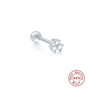 Macro detail of sterling silver piercing stud with three clear zircon stones and ball end