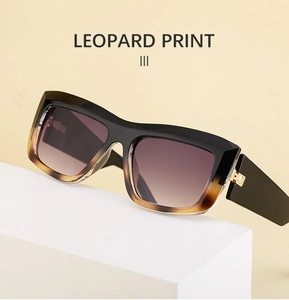 Detail of leopard print cat eye sunglasses featuring metal hinges and polished frames