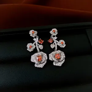 Vintage floral jewelry set with orange zircon and silver finish on black leather base