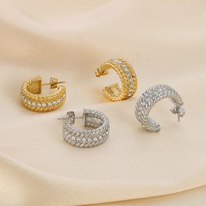 Vintage wheat twist C-shaped zircon earrings in gold and silver on silk background