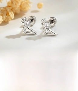 Macro detail of silver music note stud earrings in titanium steel with round zircon