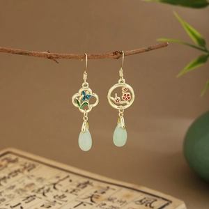 Detail of fan-shaped bamboo leaf earrings with green tassels and jade-like drops