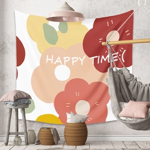 Detail of bohemian tapestry with colorful floral patterns and HAPPY TIME text on a grey wall