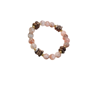 Handmade beaded bracelet with pink quartz and dark wood beads on a clean white background