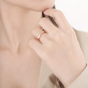 Close-up of a rose gold octagon ring featuring micro-pave diamonds on model hand