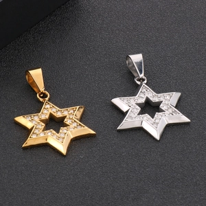 Detailed macro shot of gold and silver hexagram pendants with shimmering rhinestones