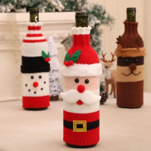 Three Christmas knitted wine bottle covers featuring Santa, snowman and elk figures