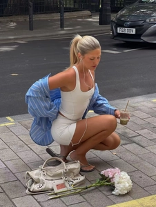Chic blue and white striped shirt paired with white leisure shorts and white tank top
