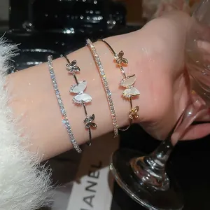Elegant butterfly and zircon bracelet set shown in luxury style with jewelry on hand